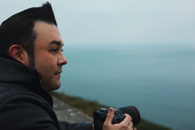 Image of Lex Hidalgo with a camera lens with an O face.
